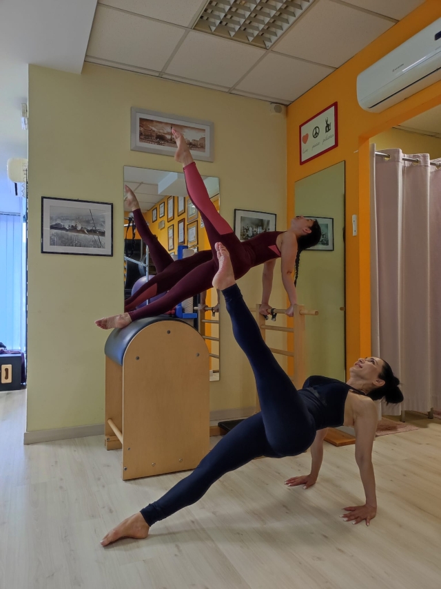 Pilates sulla Cadillac Hanging I e Bridging to stand